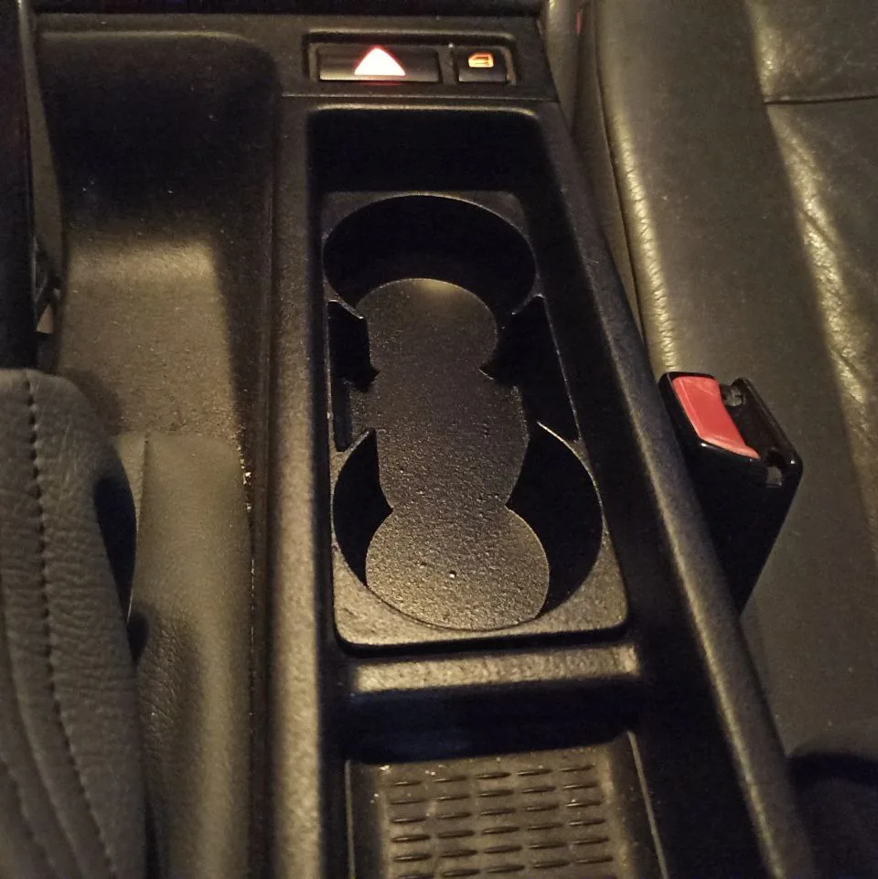 Cup holder insert in the centre console of a BMW E46