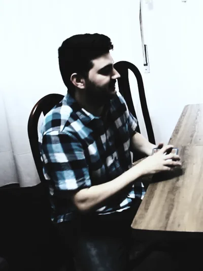 Samuel Silva at the table, in a checked shirt