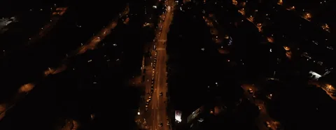 The city at night seen from above, threads of light
