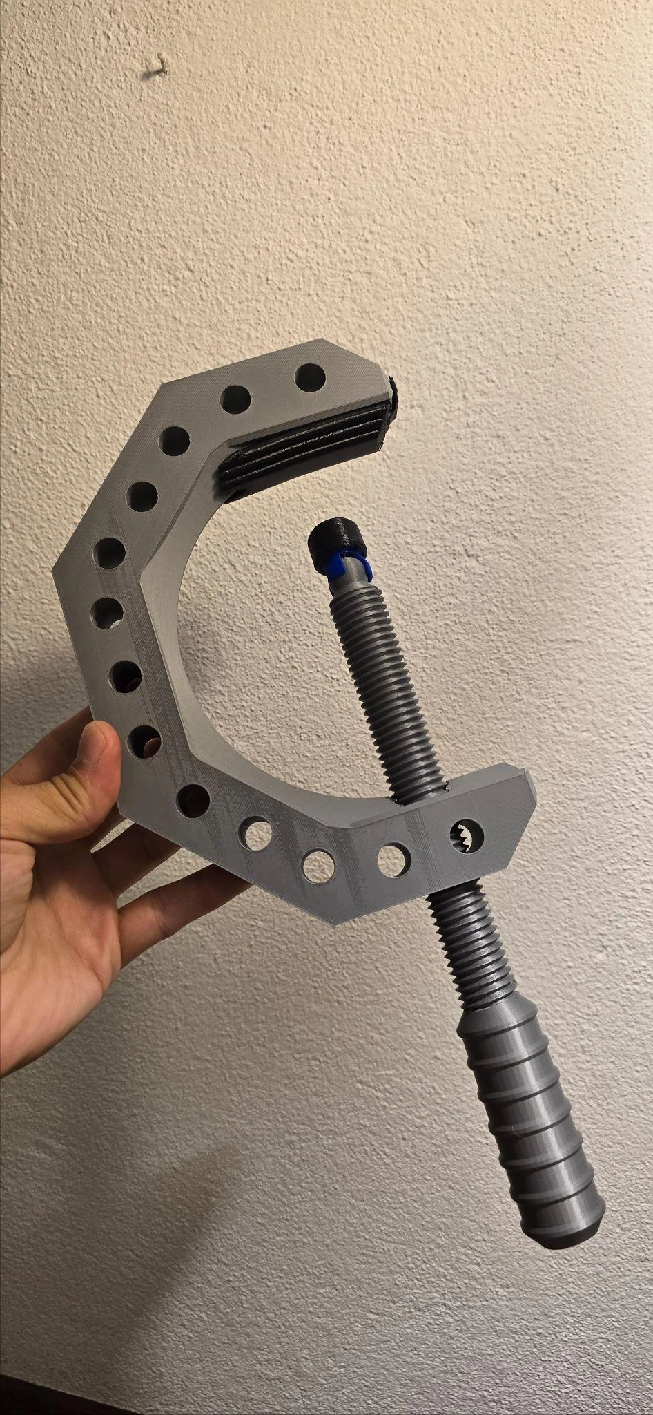 Grey printed fixed clamp held in the hand